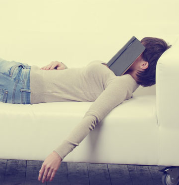 Woman lying with book next to Screw it! wine
